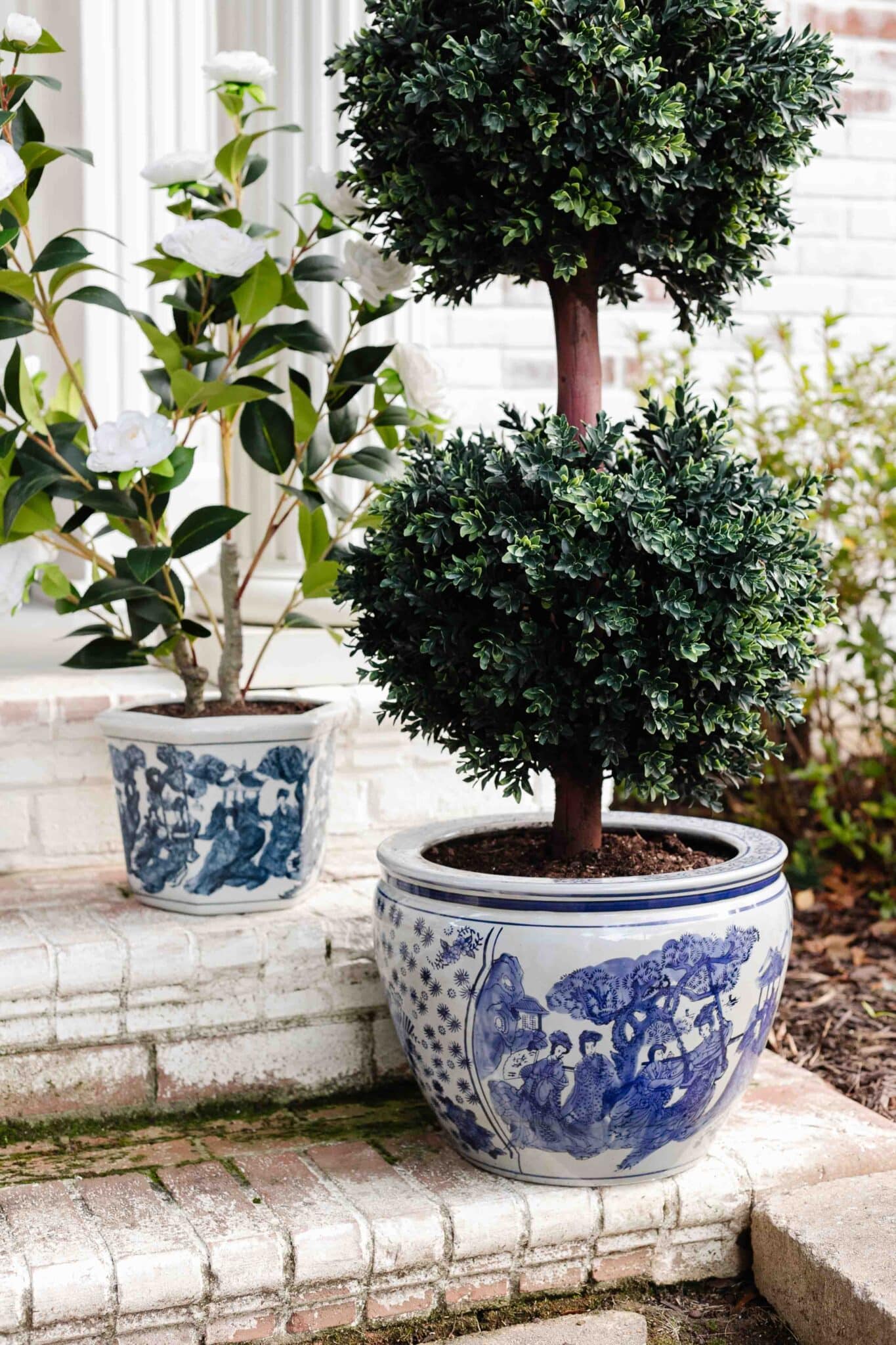 blue and white chinoiserie planters on front porch steps