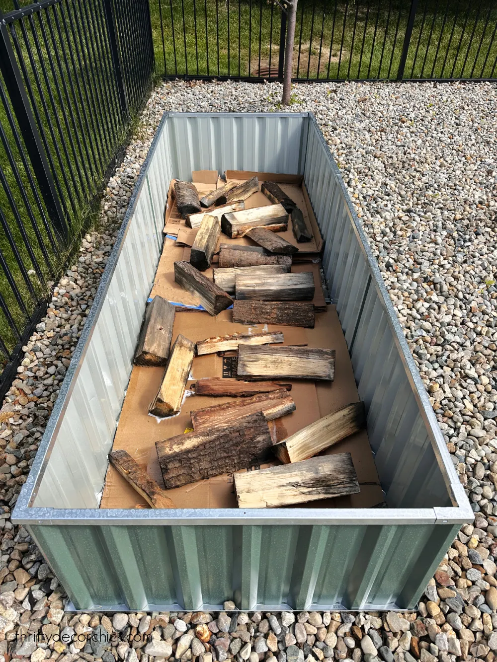 old logs in bottom of raised garden