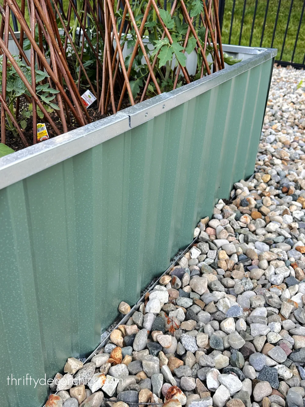 metal green raised bed in rocks