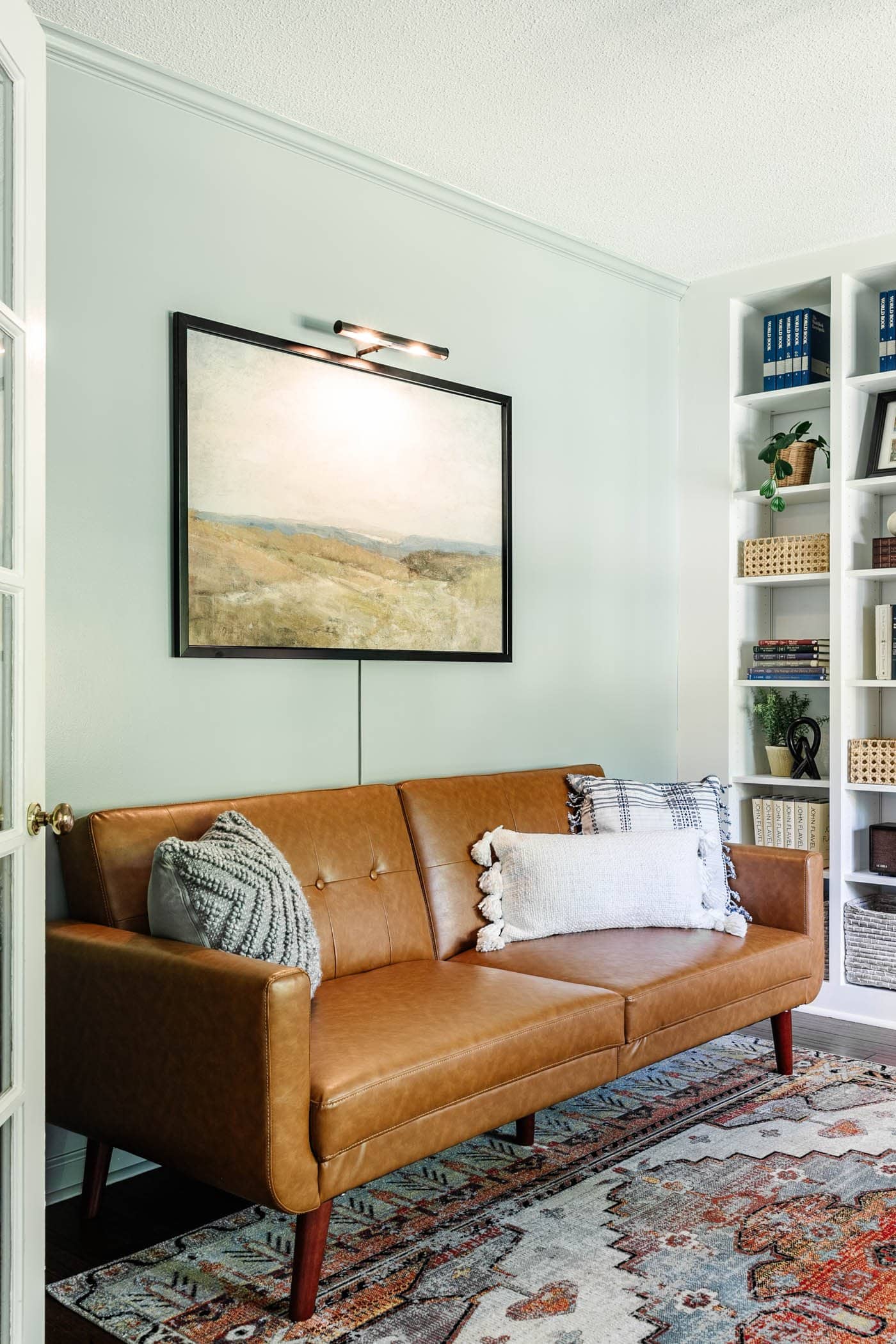 home office lounge with bookshelves and futon