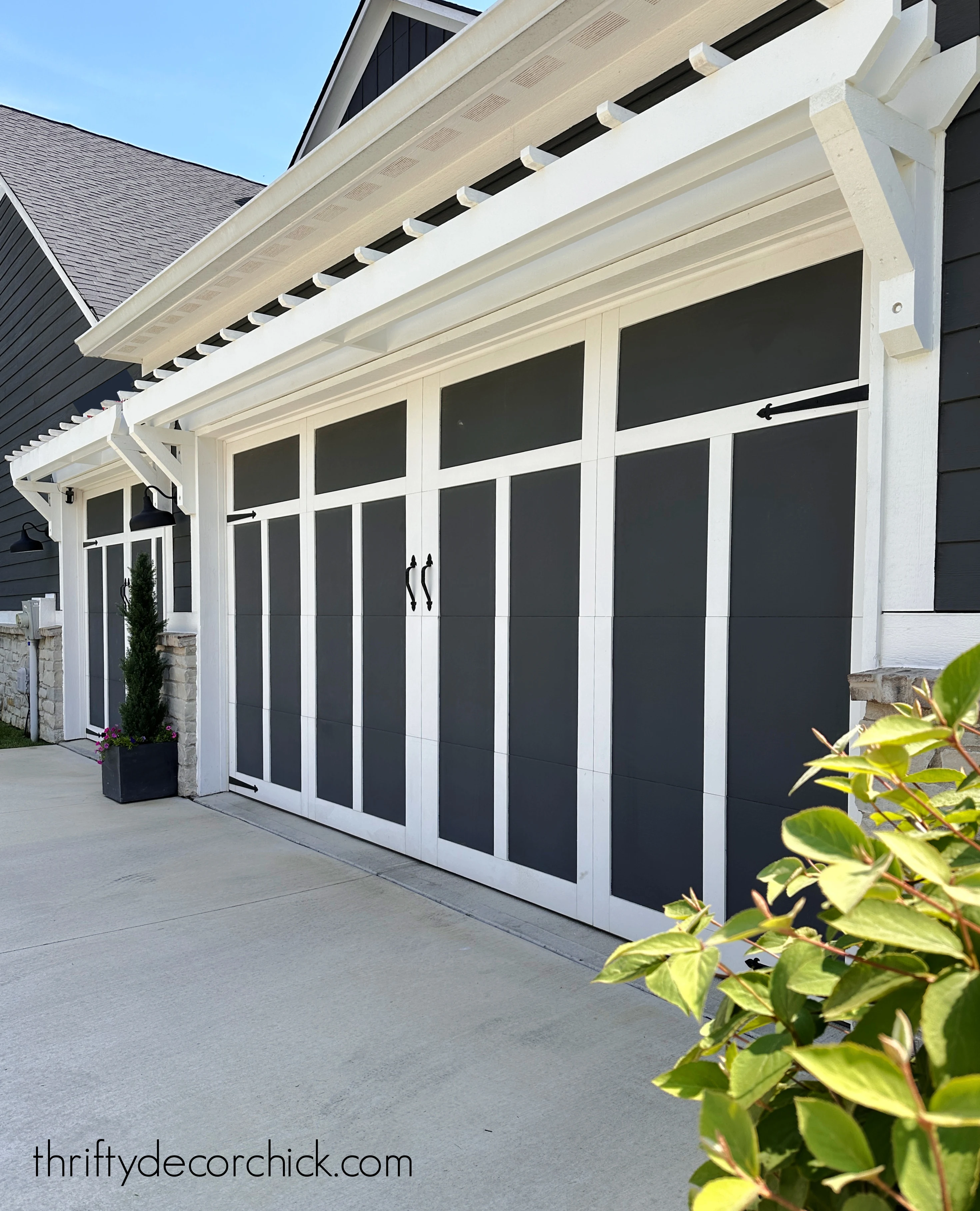 white pergola over garage doors