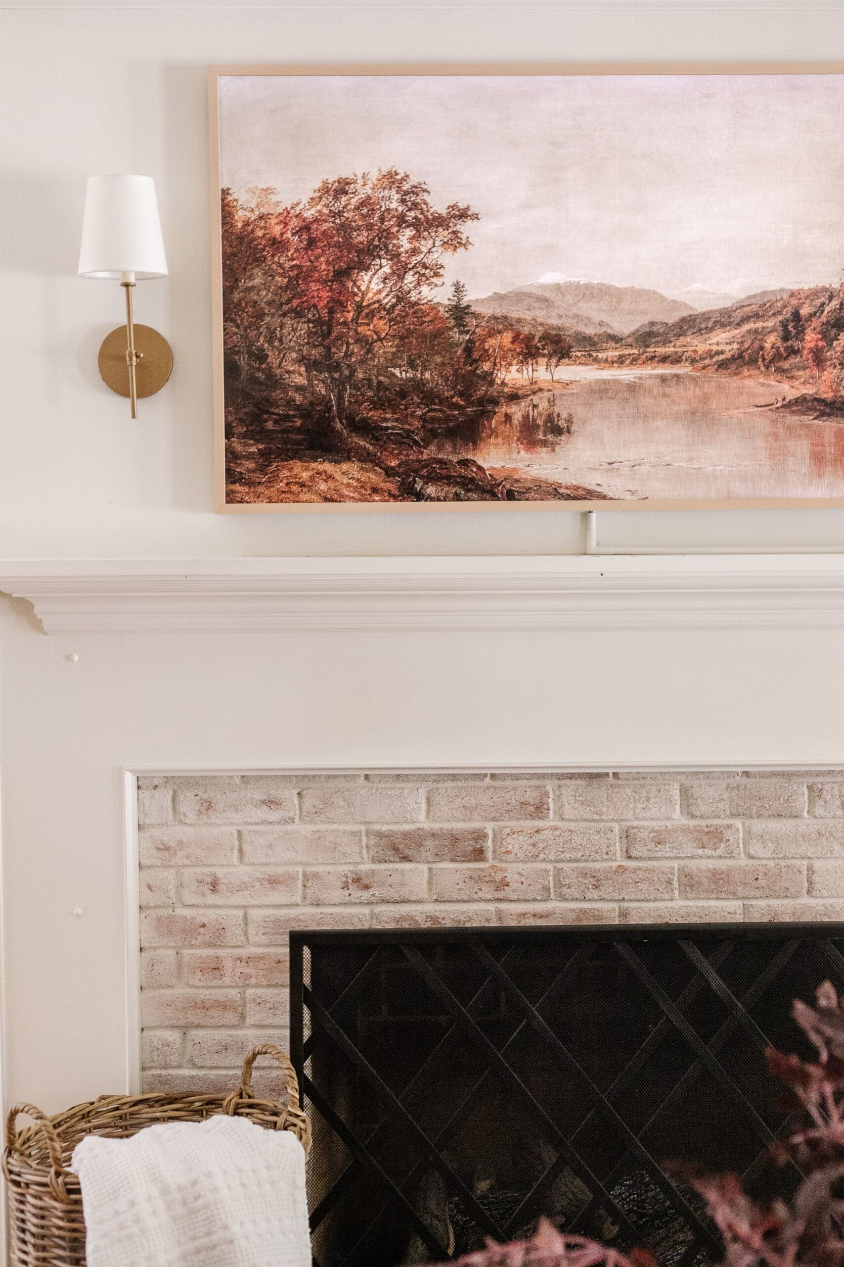 samsung frame TV with art above fireplace