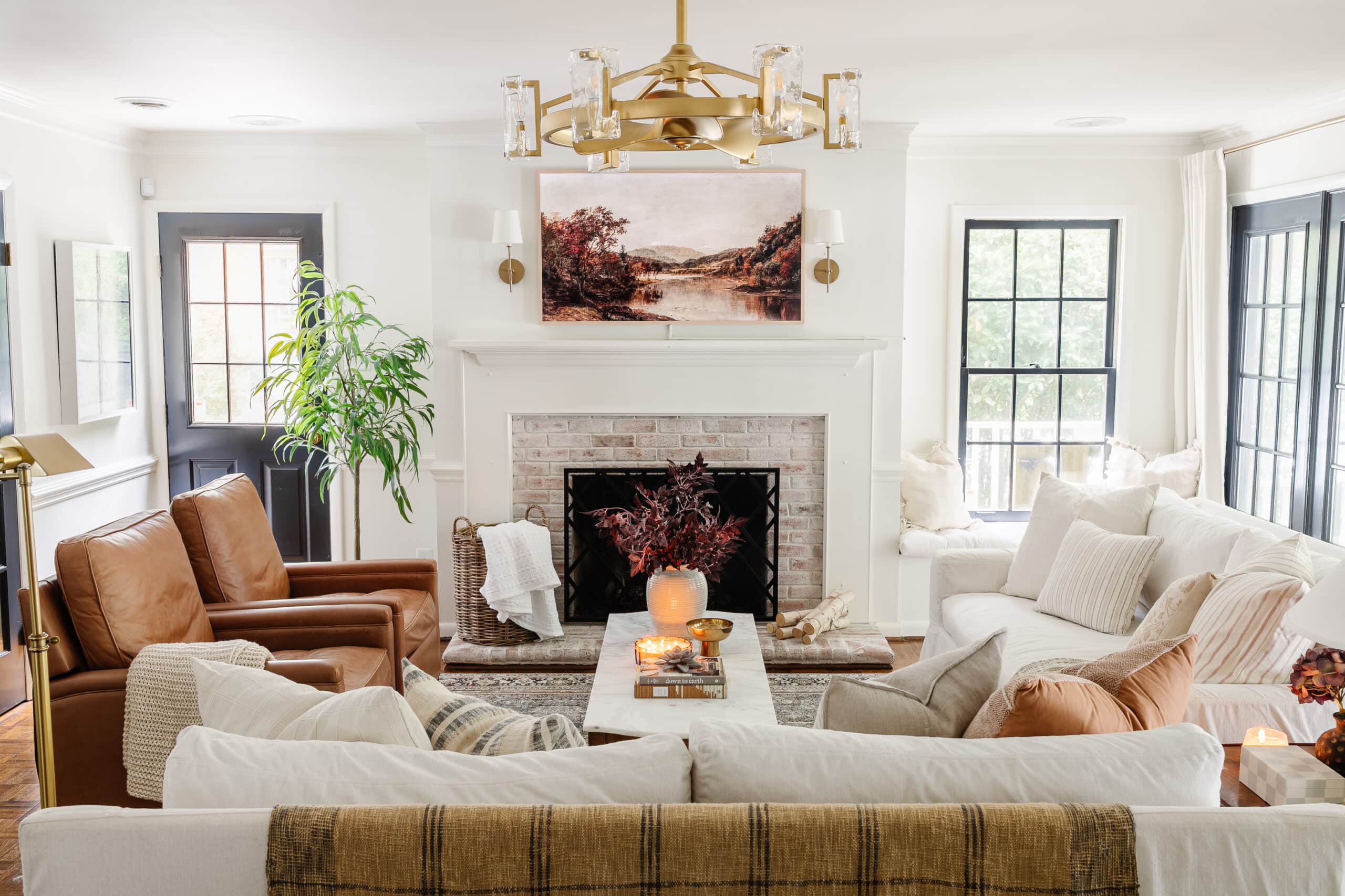 living room fall decor with white sofas and leather recliners