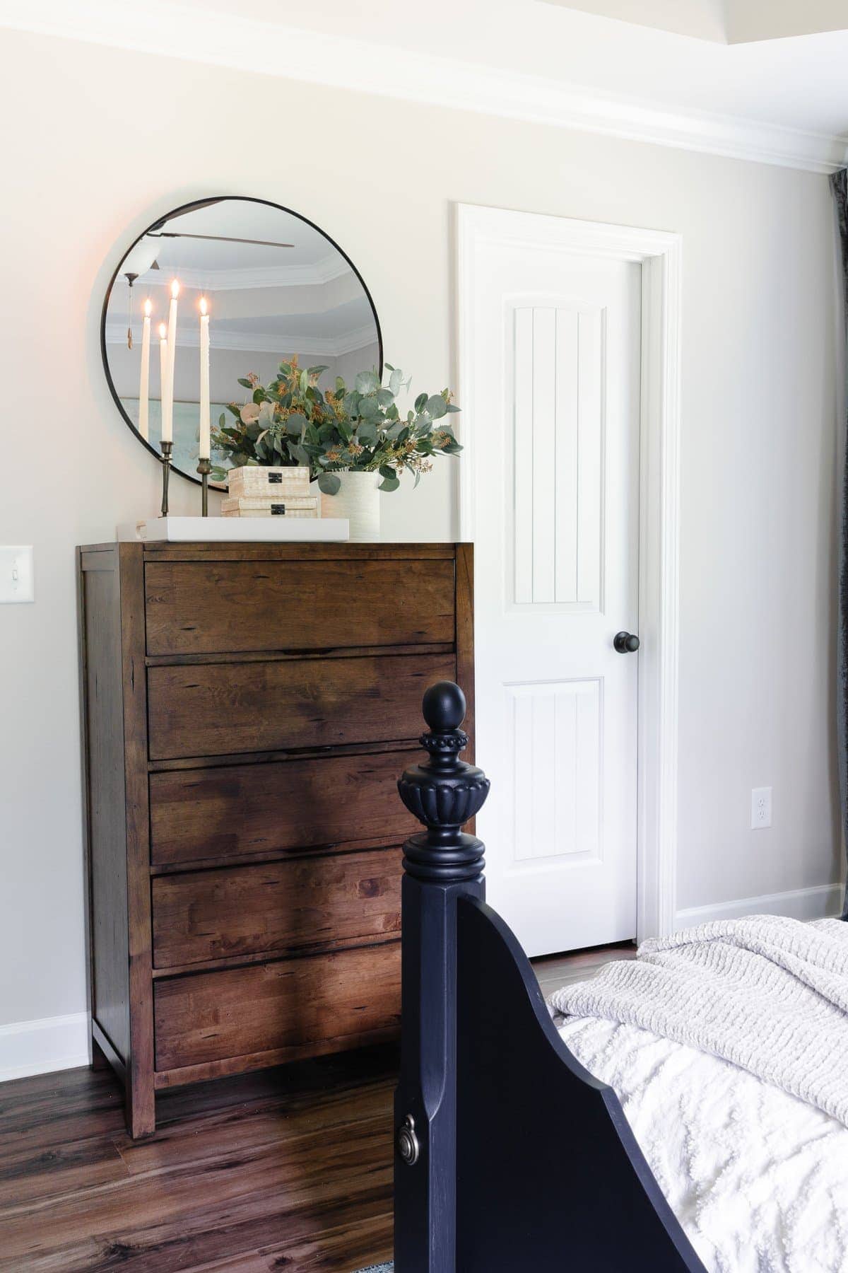 bedroom with decor on top of chest of drawers