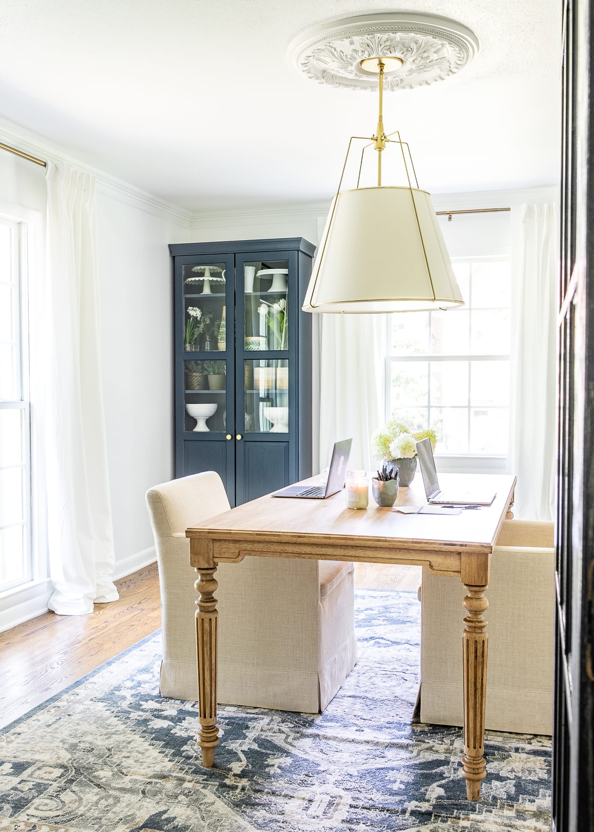 home office for 2 people with table and rolling chairs