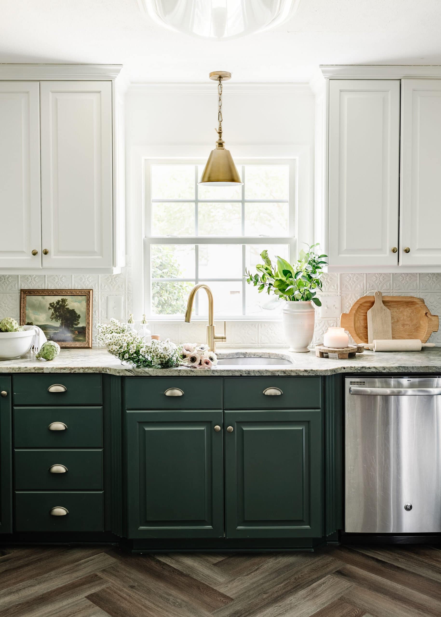 kitchen sink window with white and green cabinets