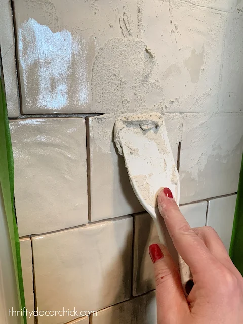 Grouting tile with putty trowel