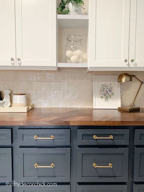 Laundry room with cream tile blue cabinets