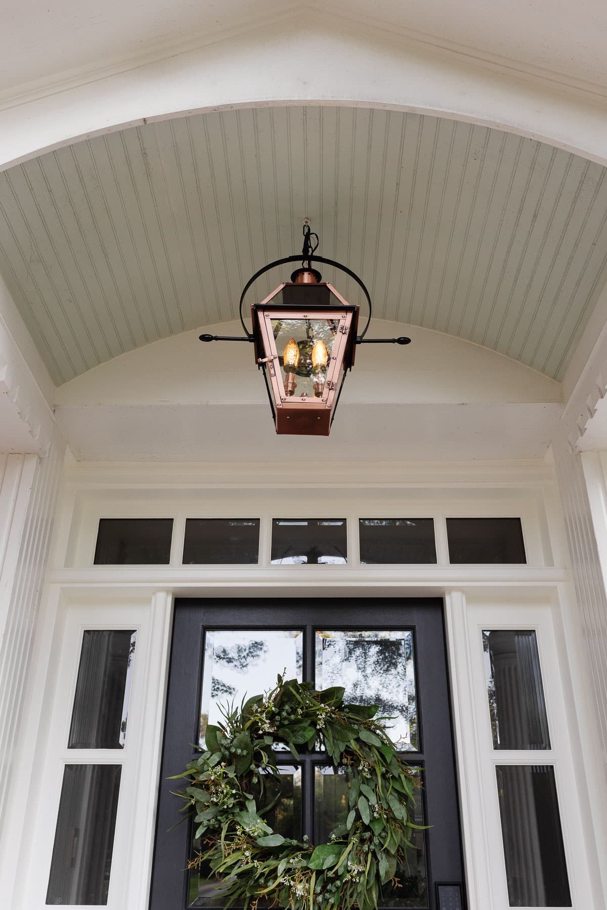 flickering flame light bulb in a lantern on a front porch