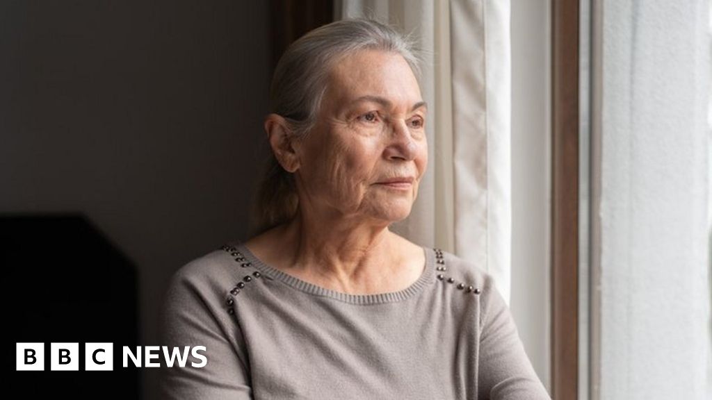 Older woman looking out the window