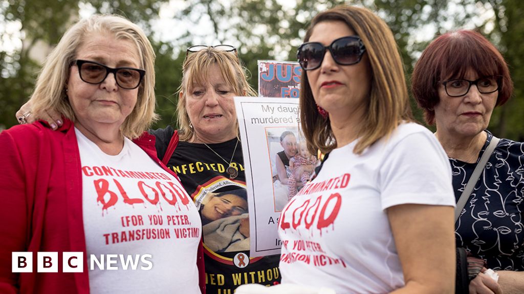 People affected by the infected blood scandal attend a vigil in Parliament Square on May 19, 2024 in London, England