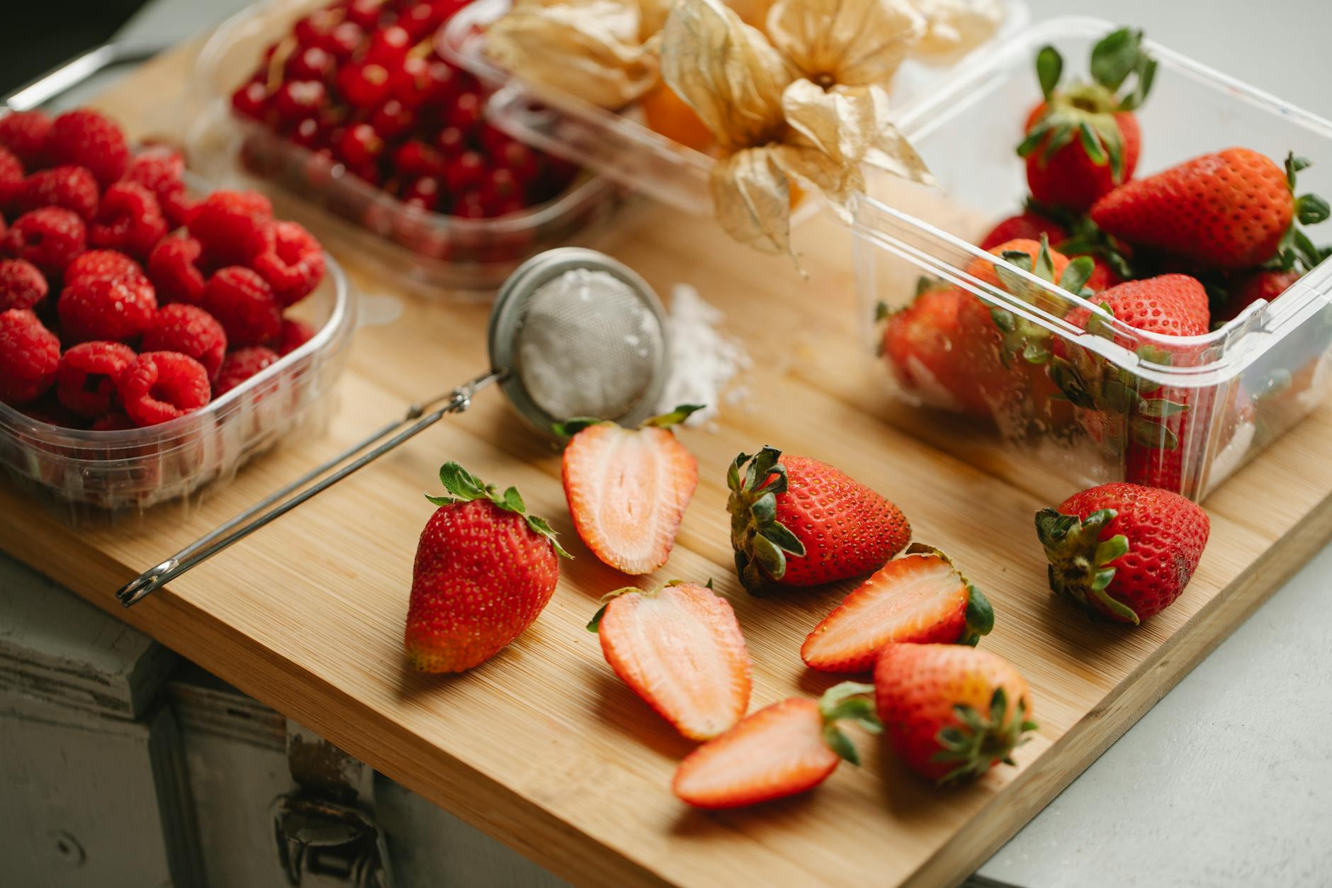 assortment of berries for garnishing on wooden board