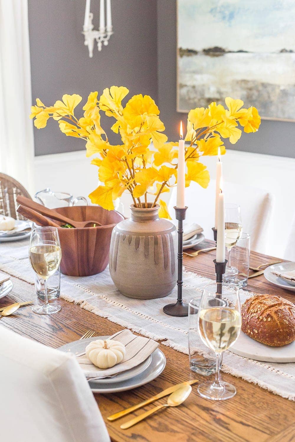 simple fall centerpiece using yellow ginkgo fall branches in a concrete vase