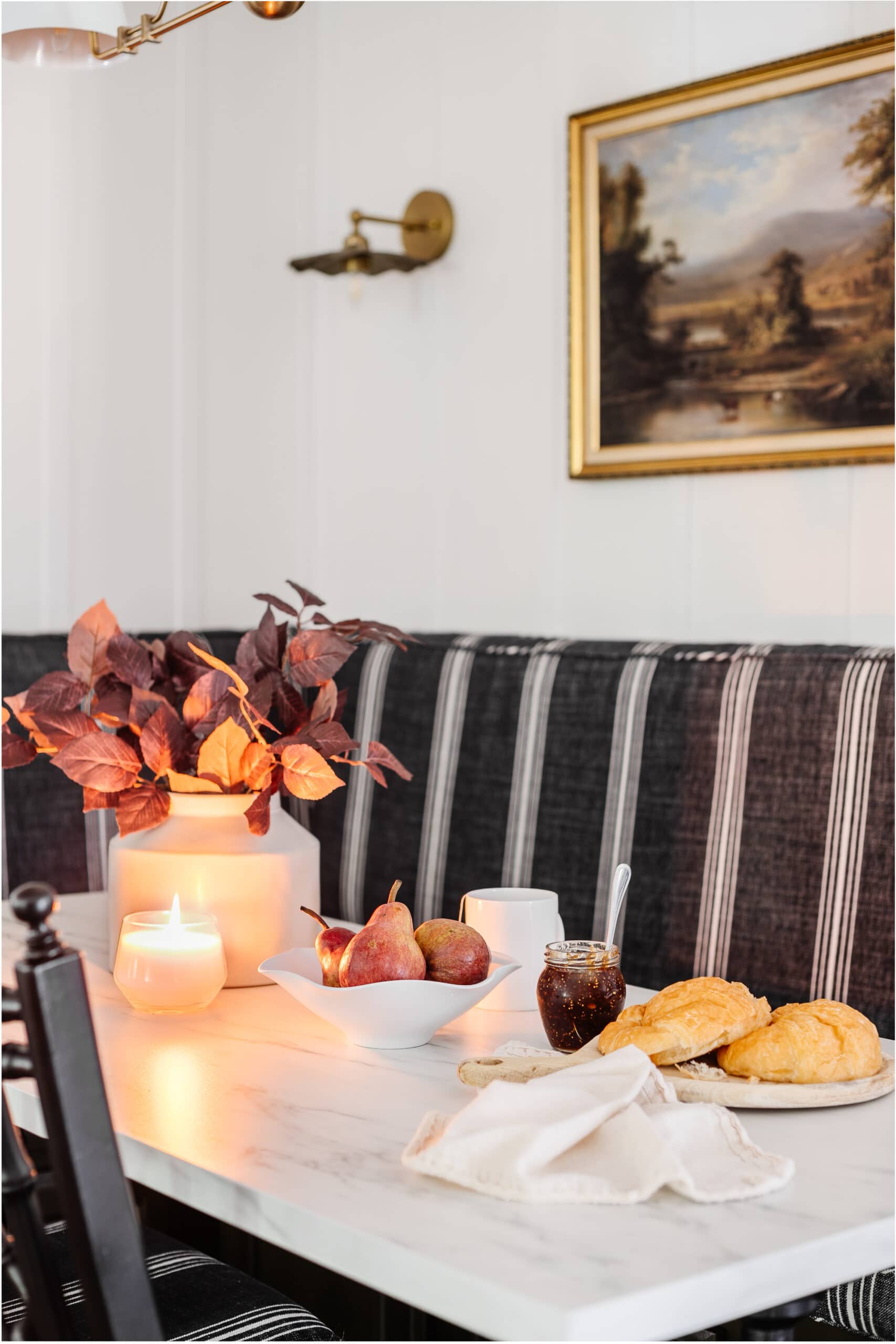 simple fall centerpiece on a breakfast table with vase of fall branches