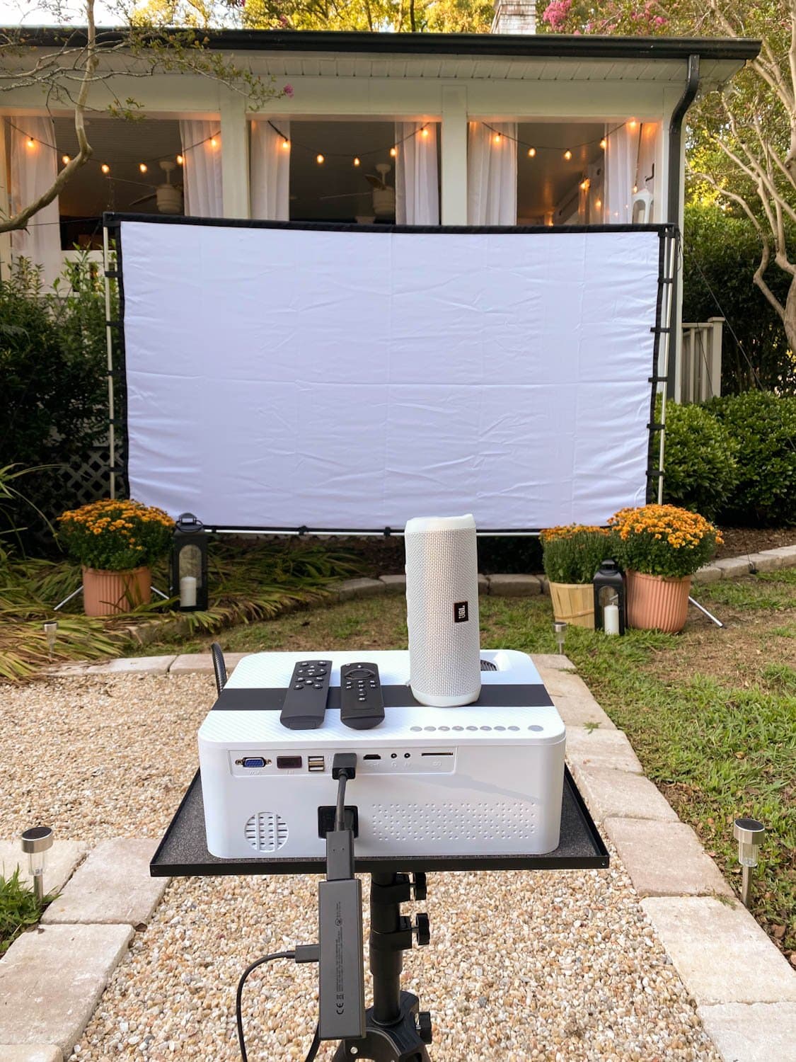 How to set up a backyard movie night with recommended projector, outdoor projector screen, movie streaming device, and bluetooth speaker