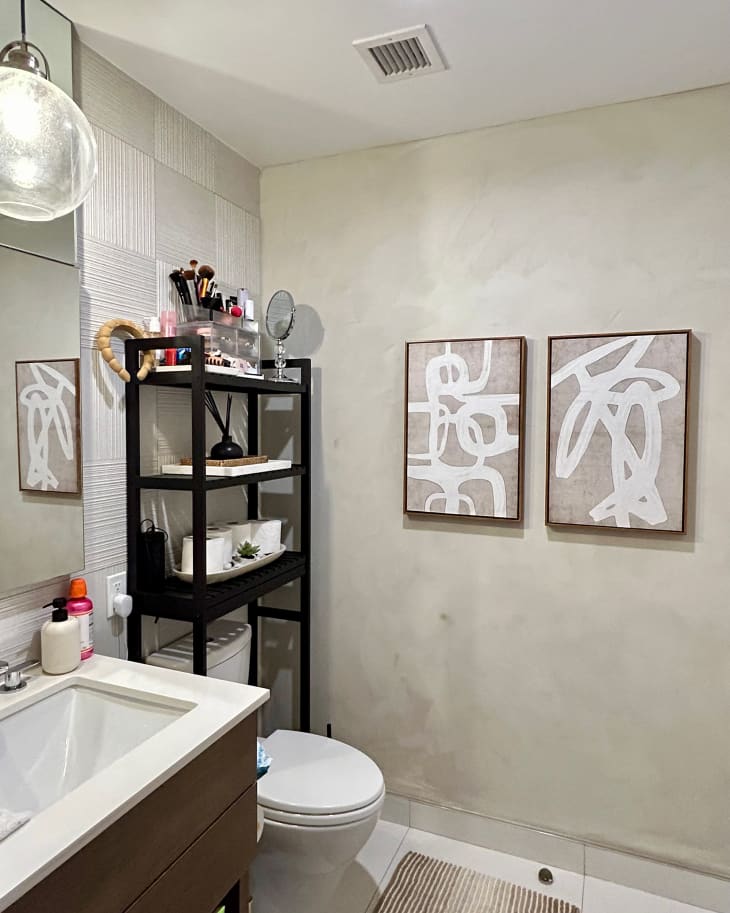 Paintings mounted in bathroom with limewashed walls.