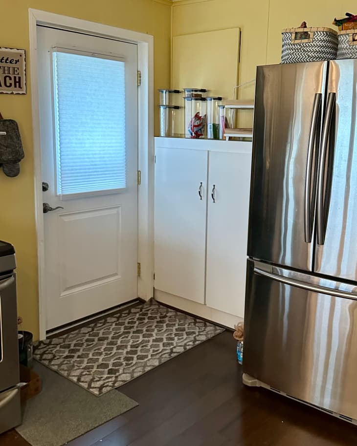 Food storage containers on top of kitchen cabinets.