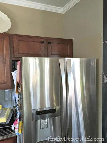 moving cabinet above fridge