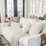 neutral throw pillows on a sofa in a living room with fall decor