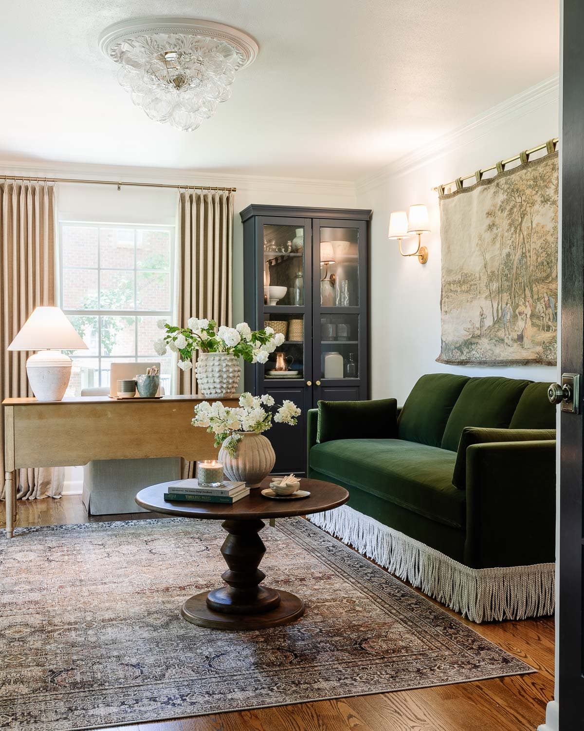 home office with green velvet sofa and lamps