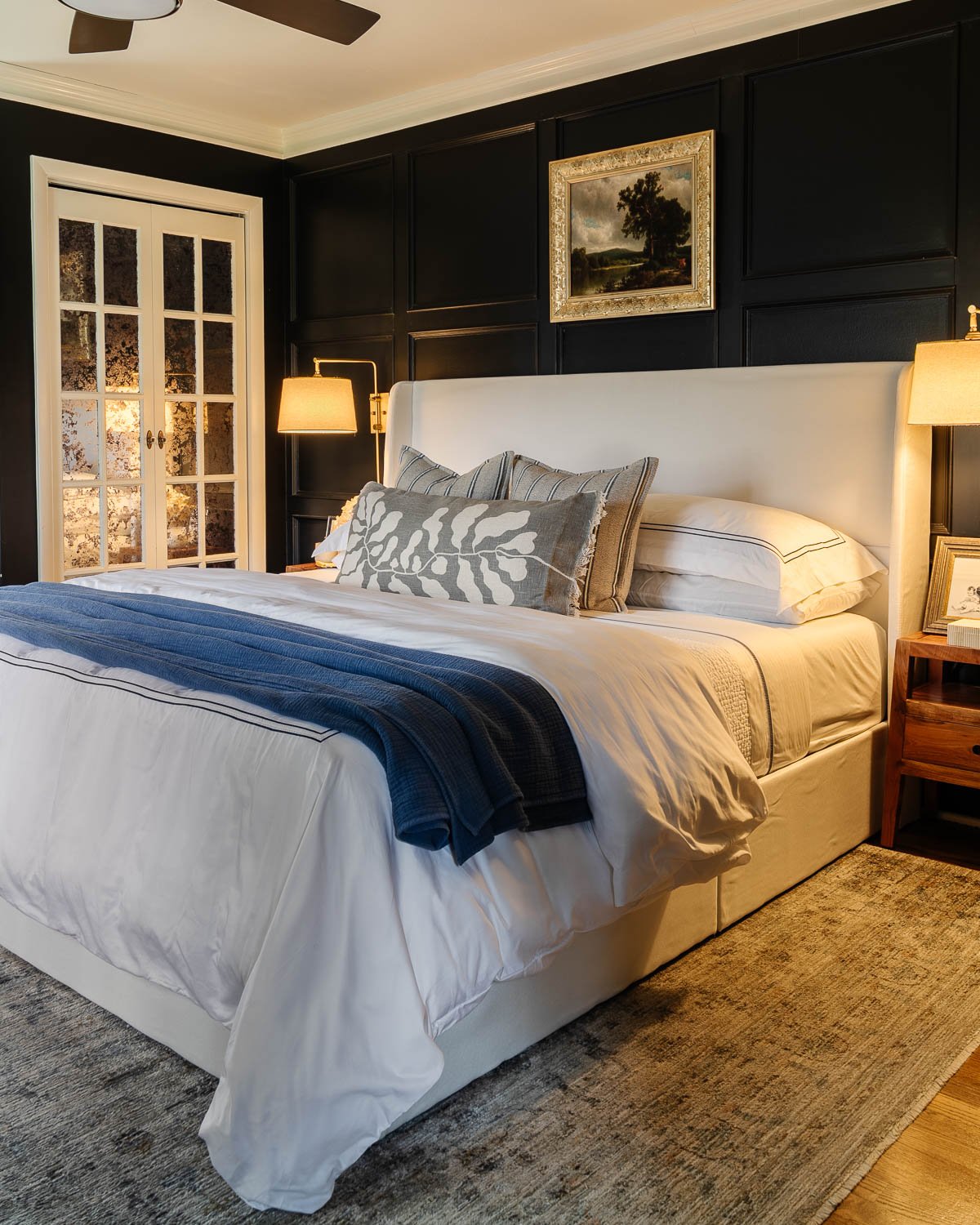 black and white bedroom with sconce lamps above nightstands