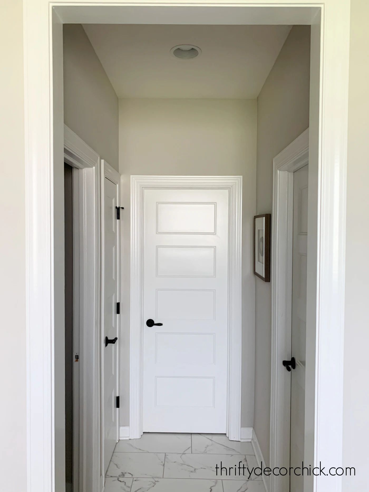 small hallway with marble tile