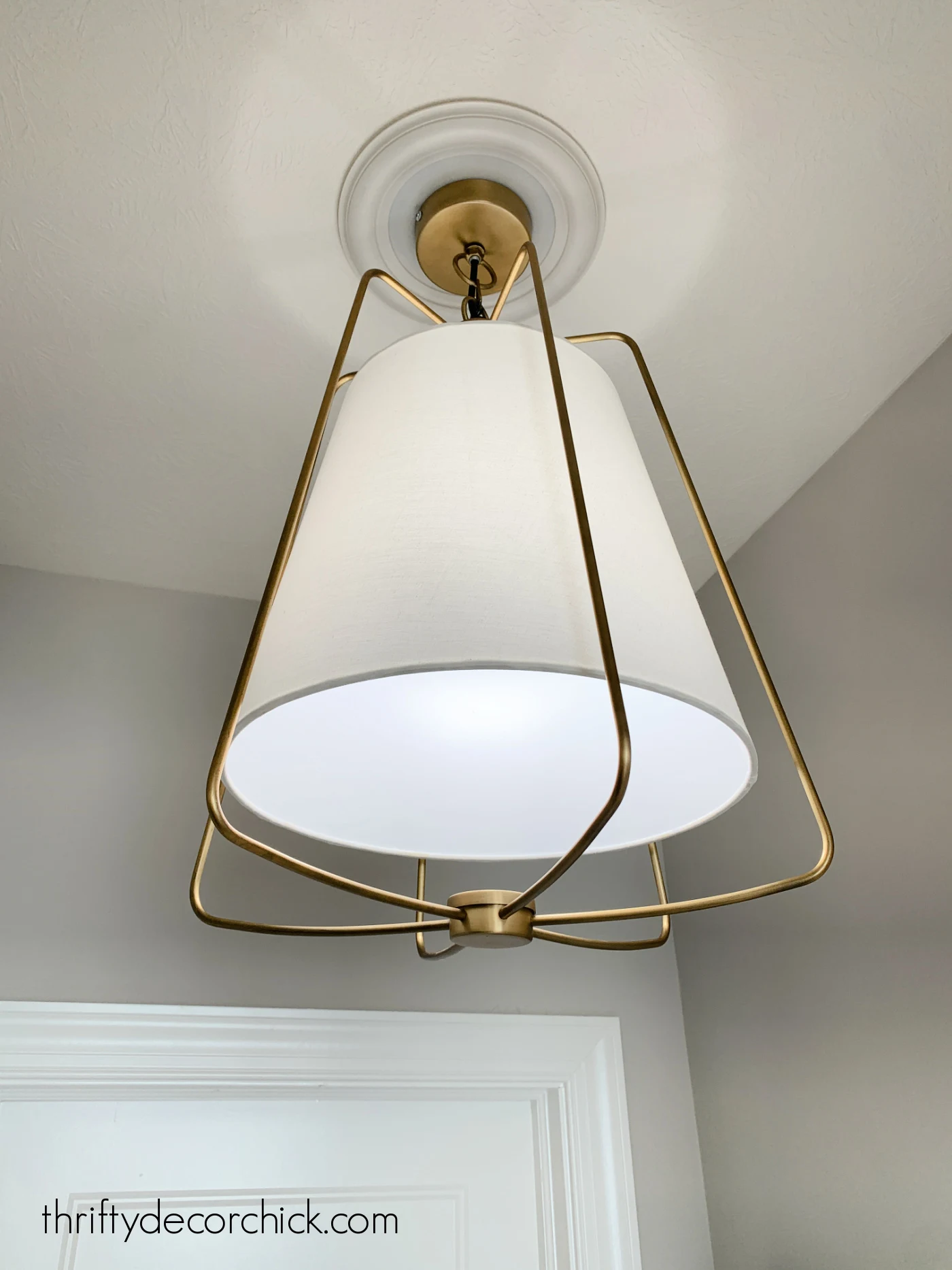 brass and white lamp shade light fixture