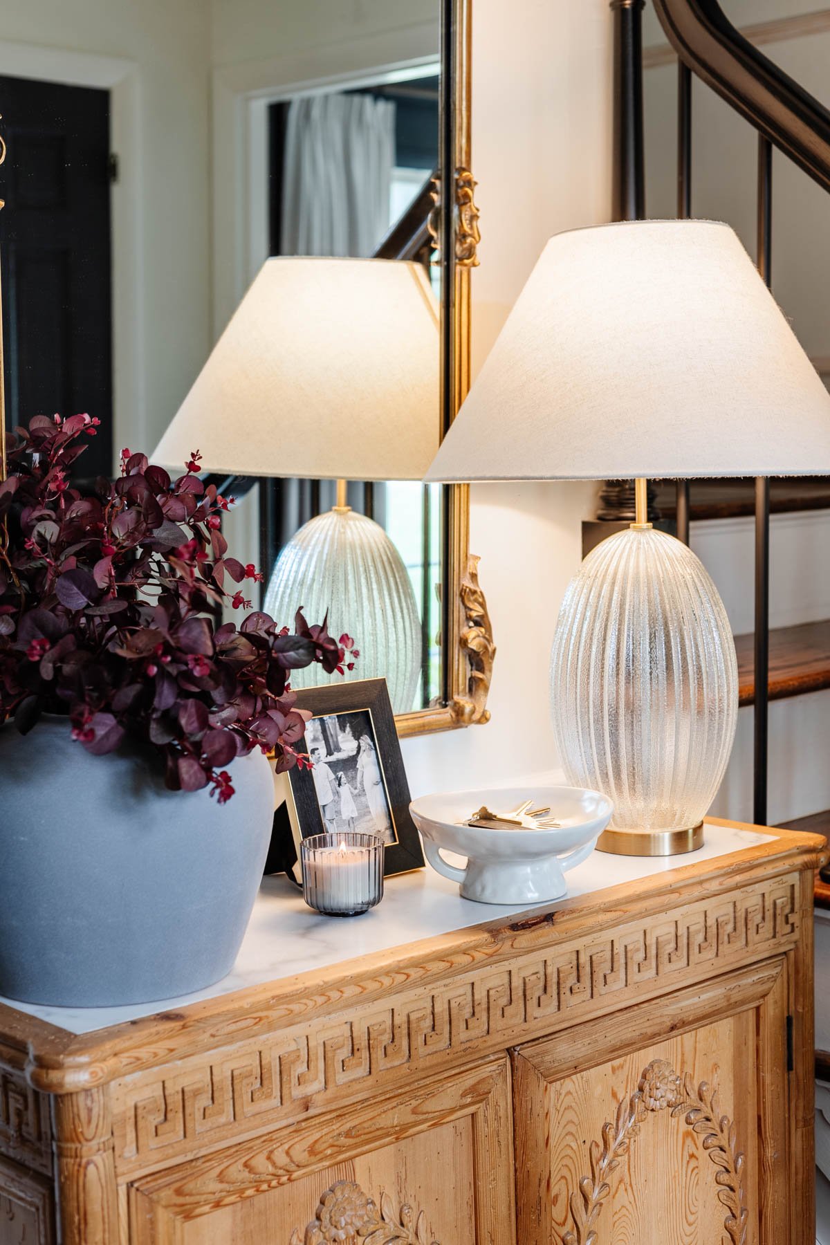 pedestal bowl used as a key holder on an entryway table