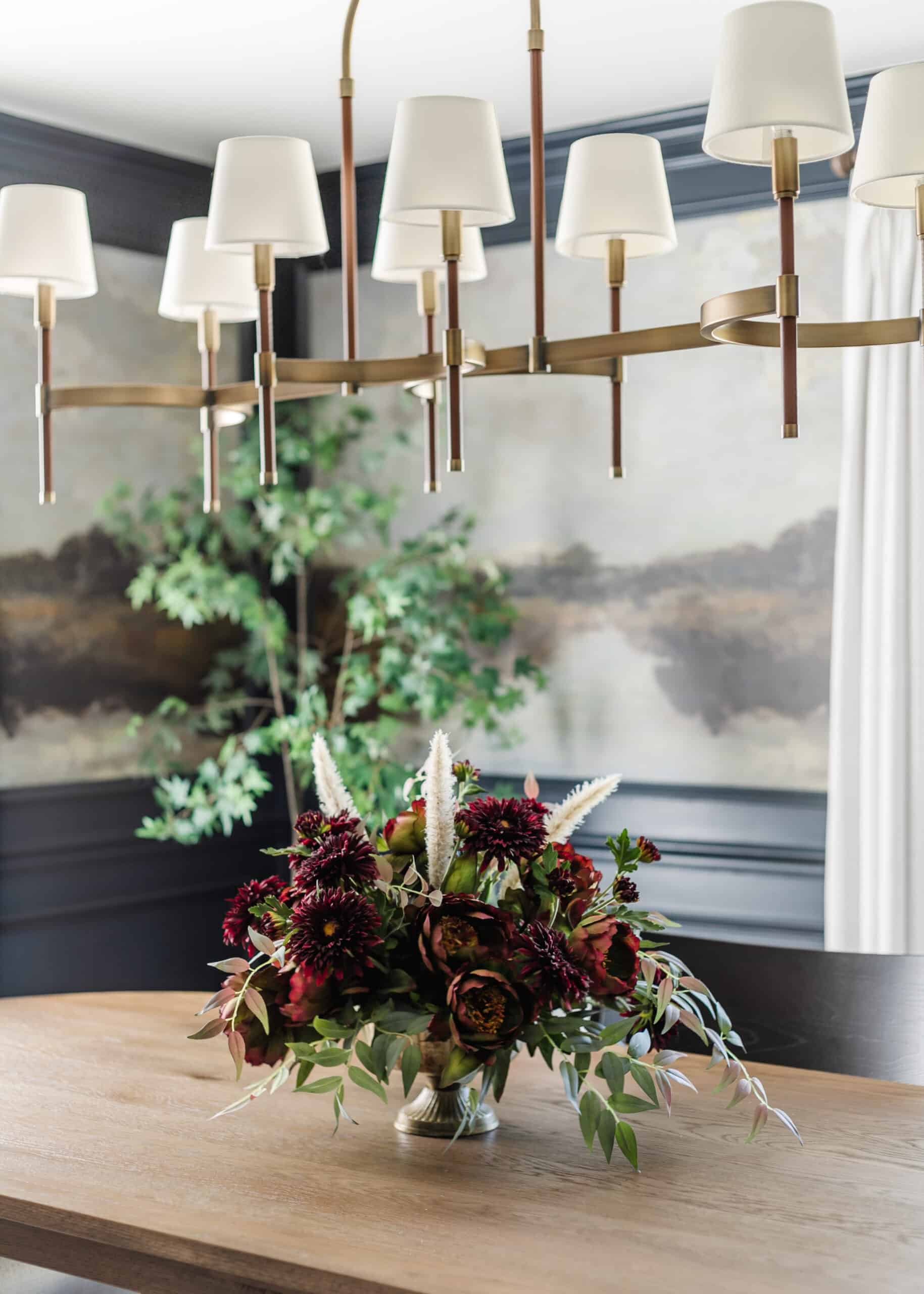 compote bowl floral centerpiece on a dining table