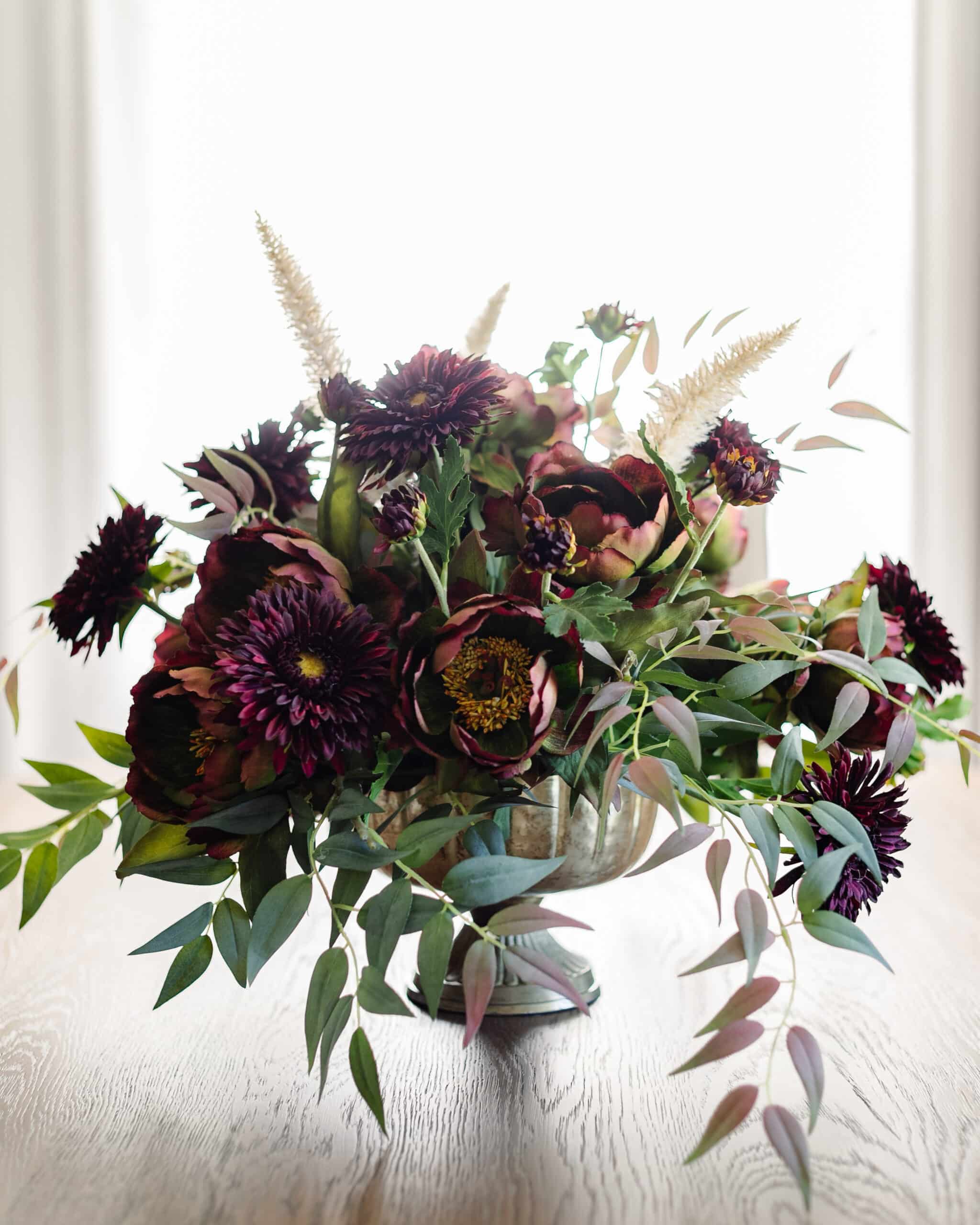 compote bowl flower arrangement centerpiece on a dining table