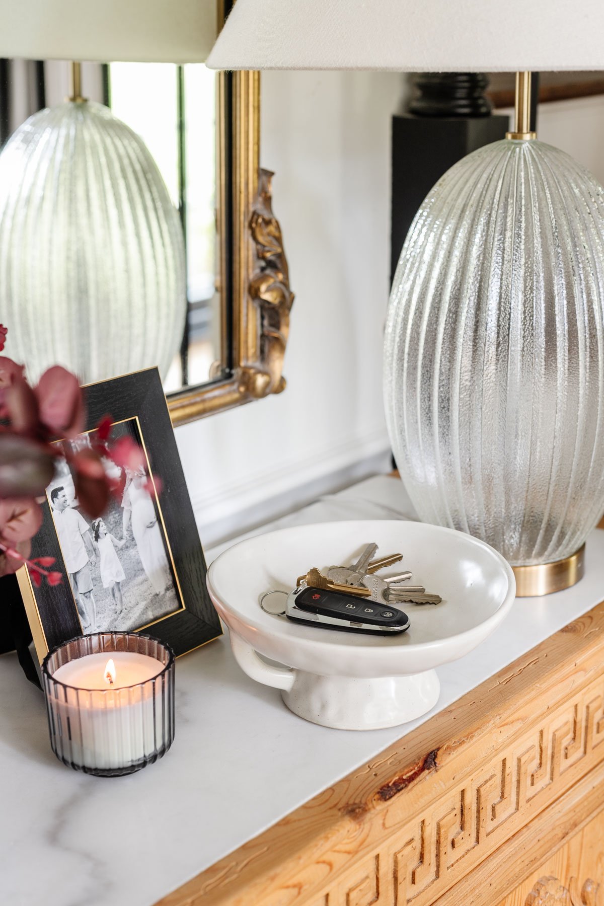 pedestal bowl used as a key holder on an entryway table