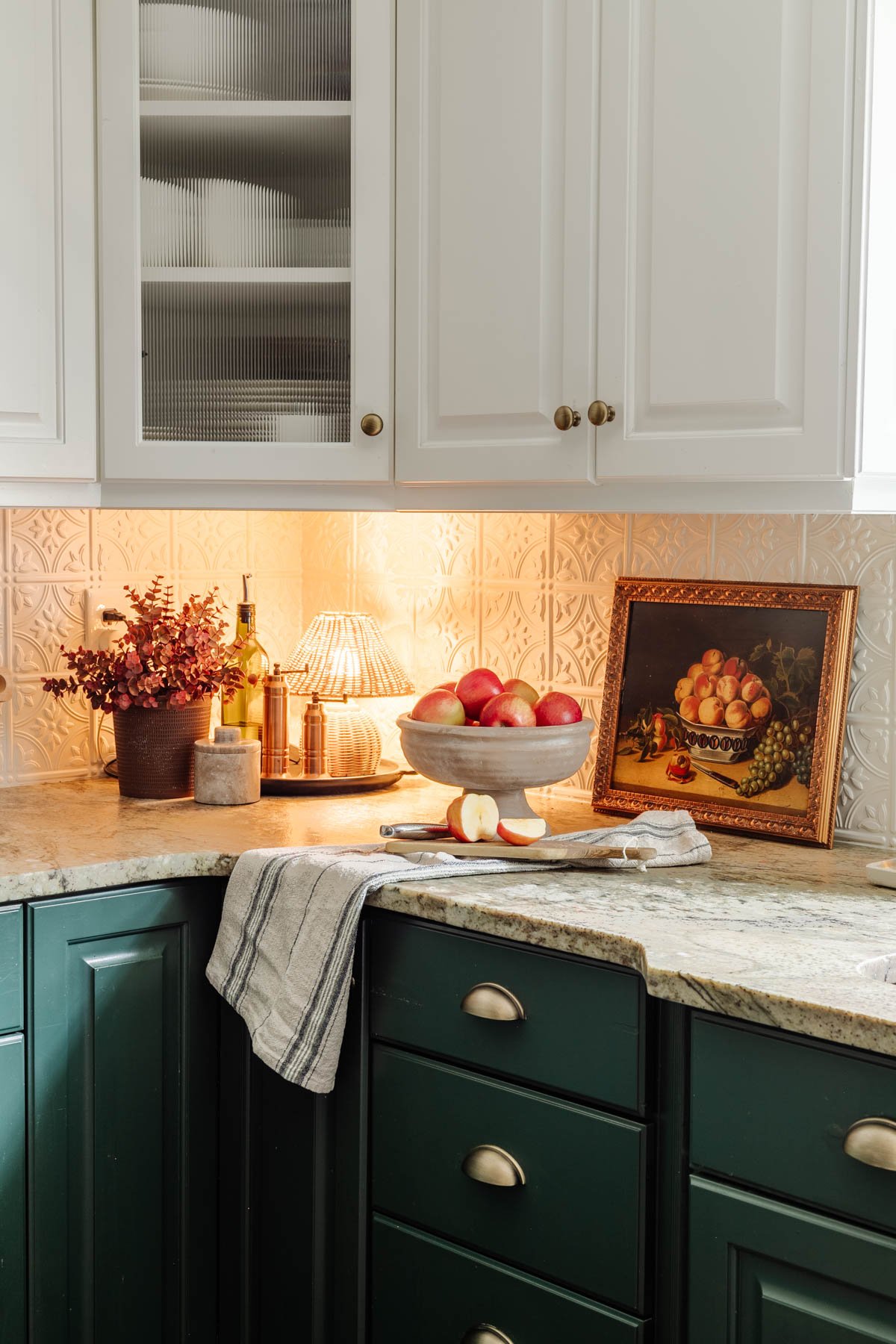 footed bowl used as a fruit bowl on a kitchen countertop