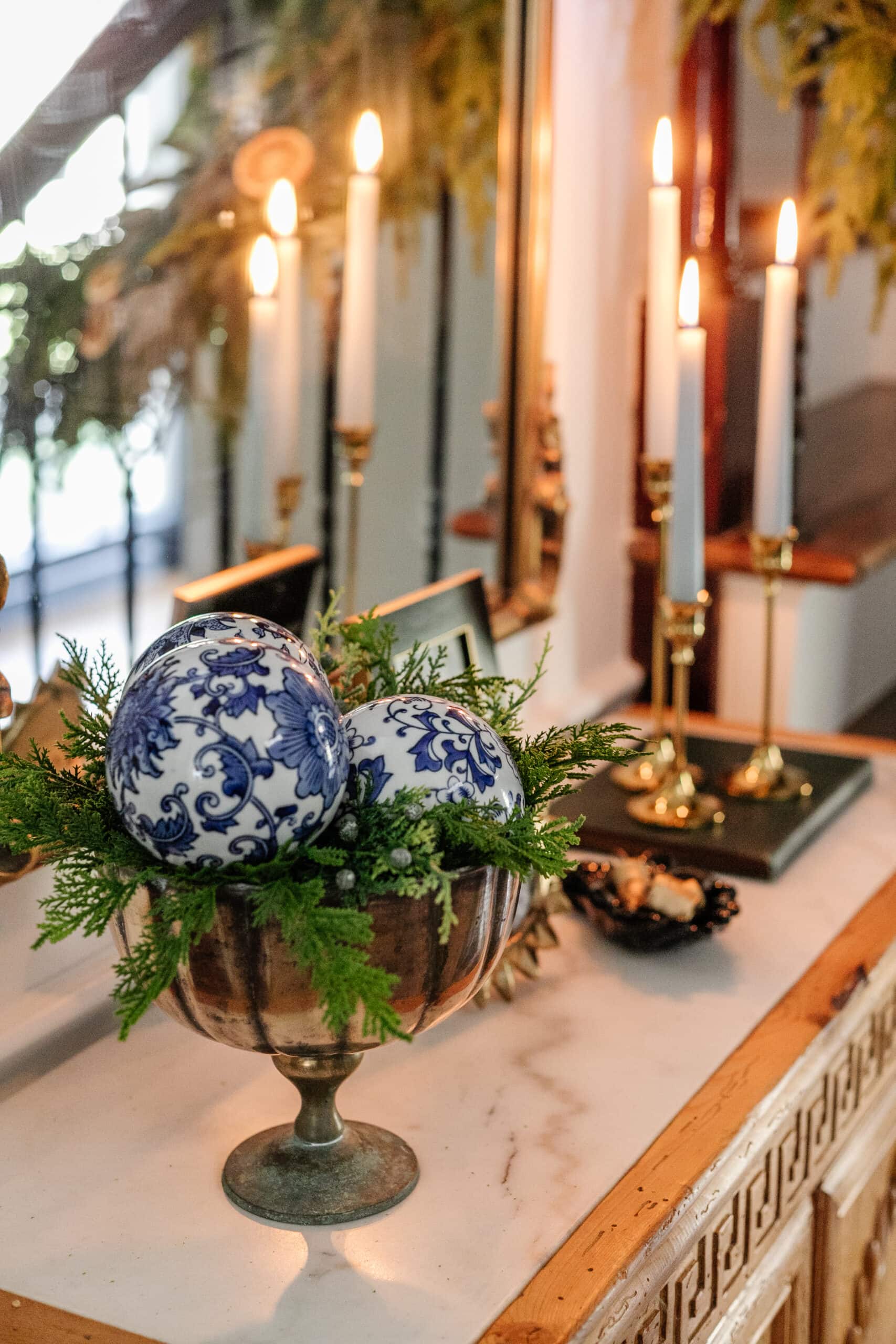 pedestal bowl filled with greenery and ornaments for Christmas decor