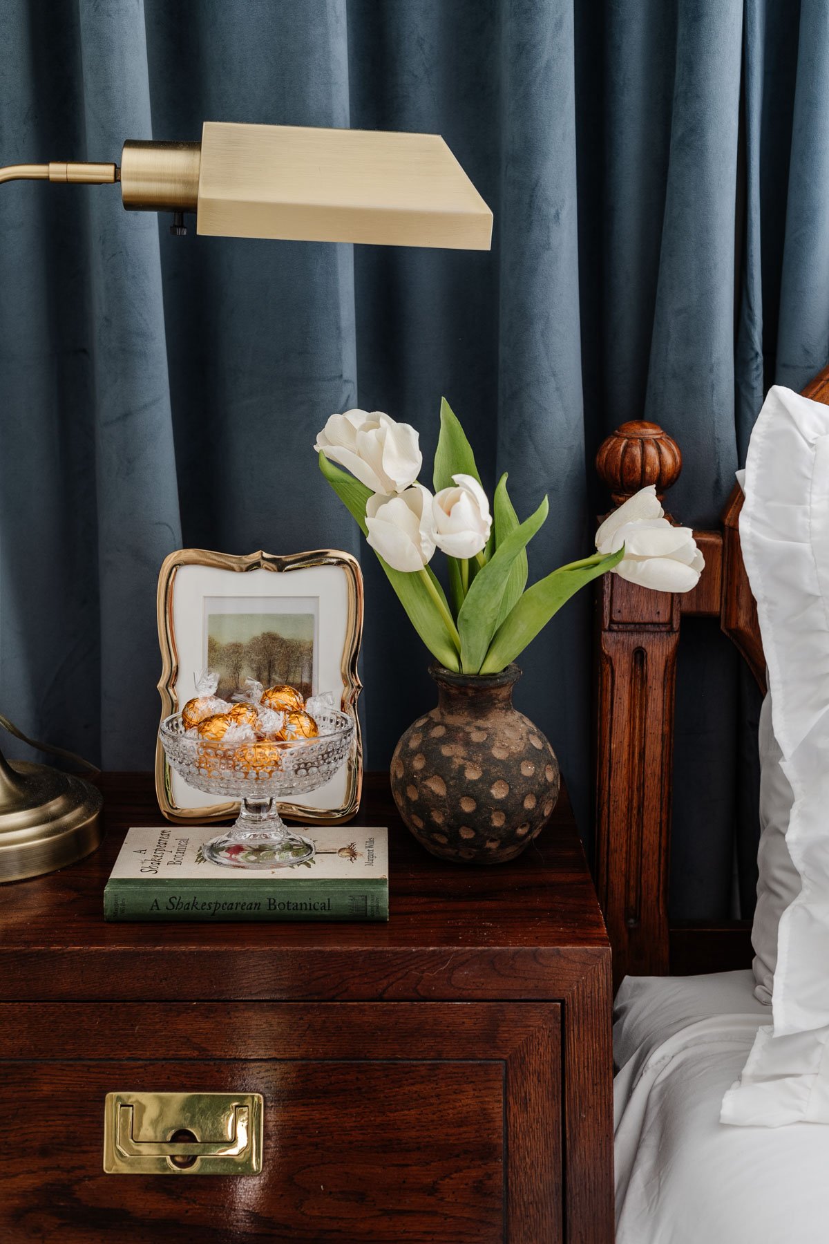 glass footed bowl used as a candy dish on a guest bedroom nightstand