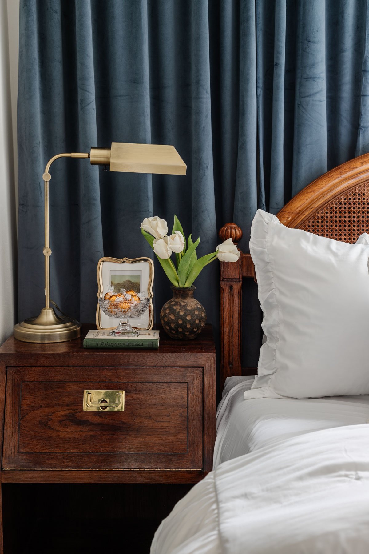 glass footed bowl used as a candy dish on a guest bedroom nightstand