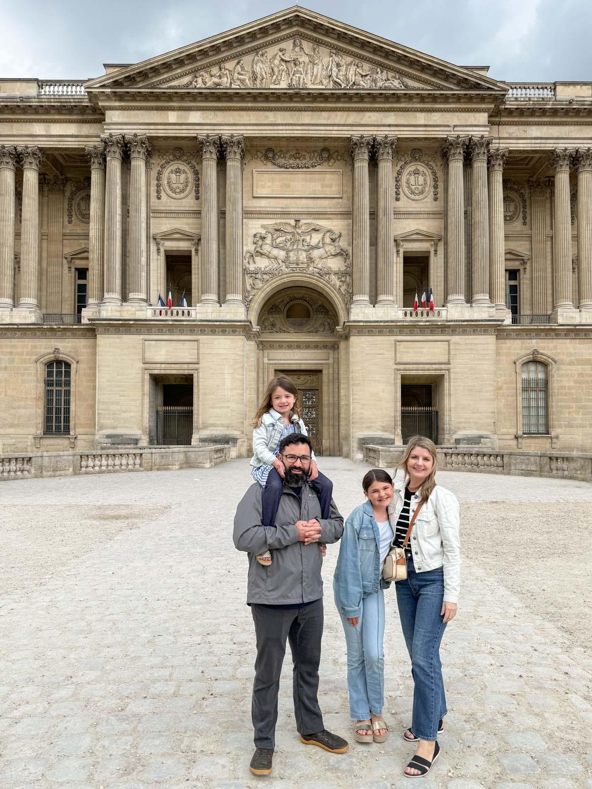 family in front of the Louvre