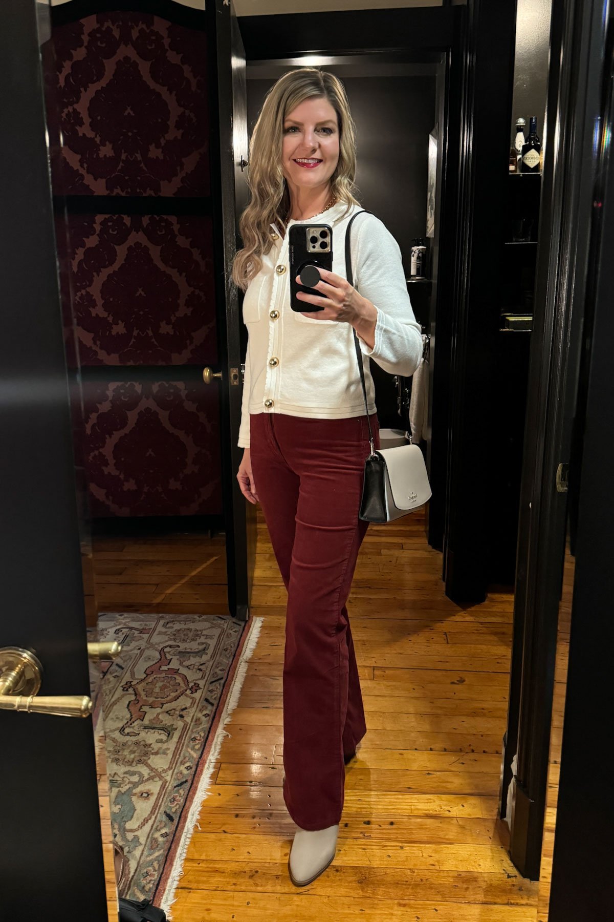 outfit with red corduroy pants and white cropped sweater