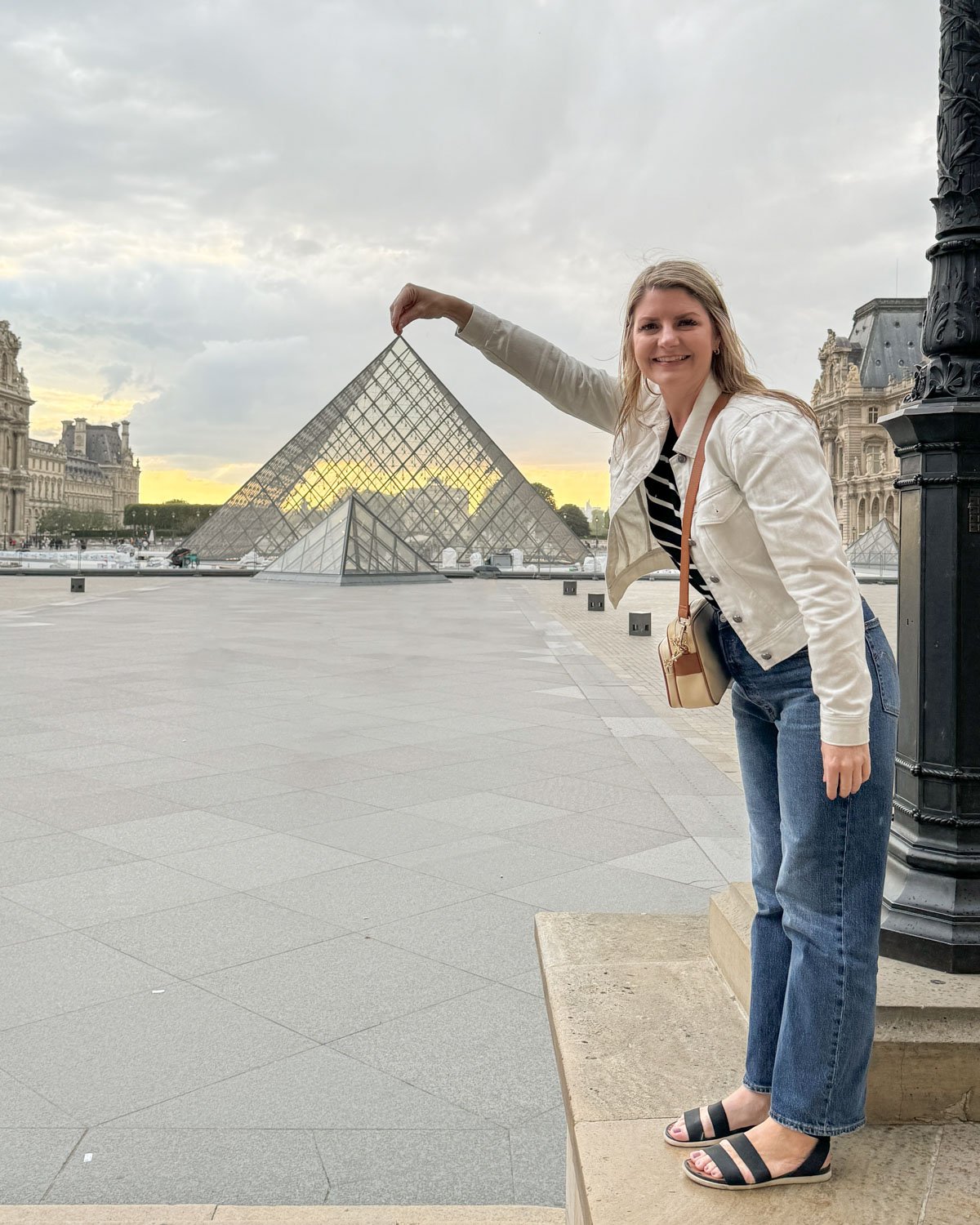 woman in front of the Louvre pyramid