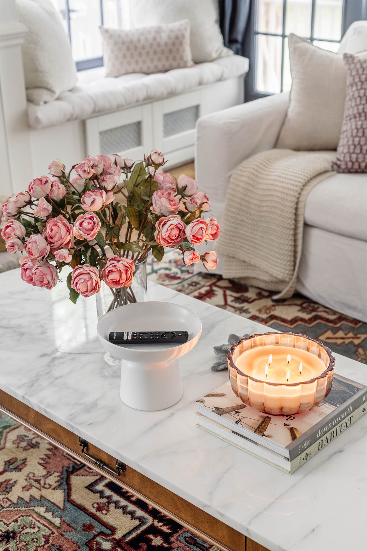 pedestal bowl used as a remote control holder on a coffee table