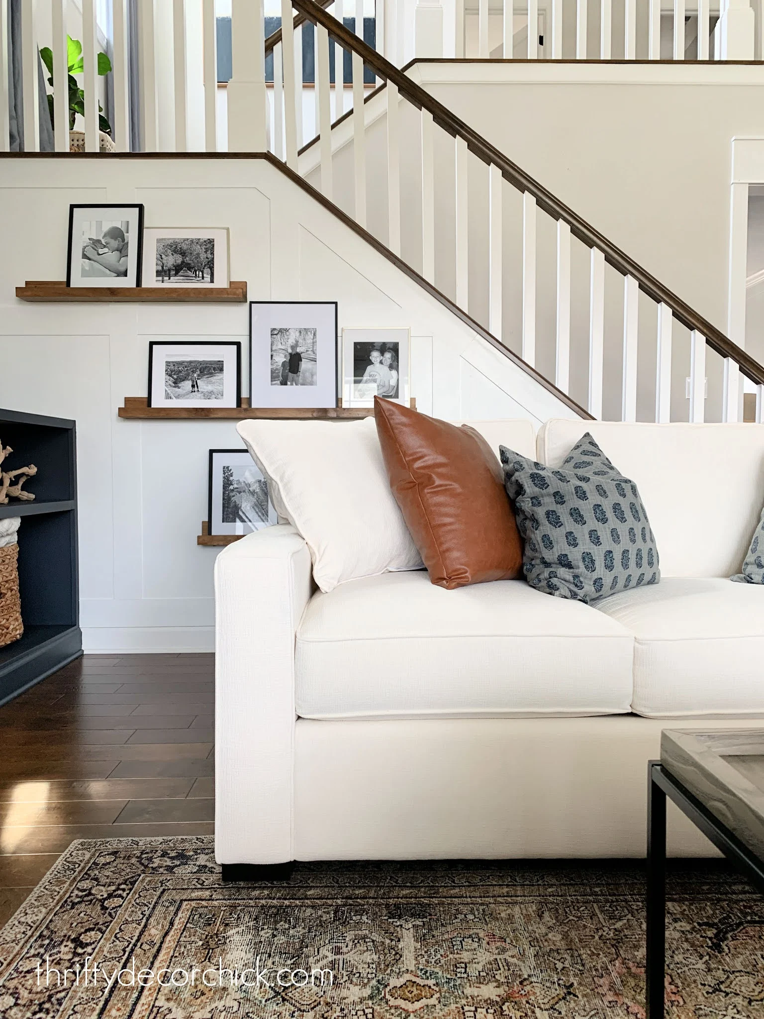 cream sofa with blue and leather pillows