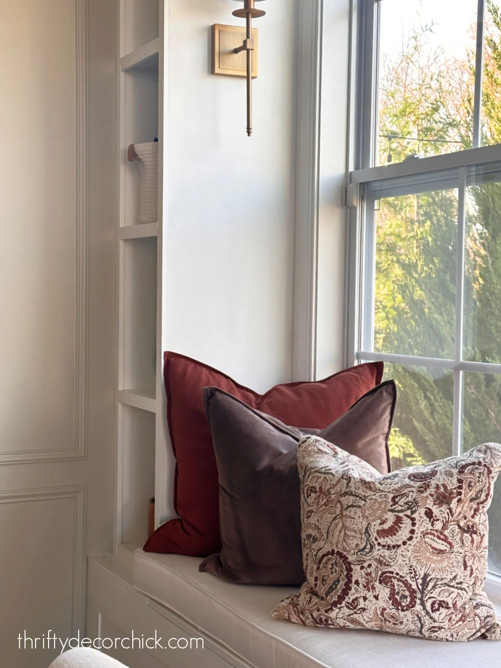 warm fall pillows on window seat