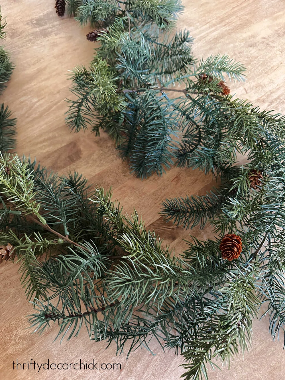 green fluffy garland with pinecones