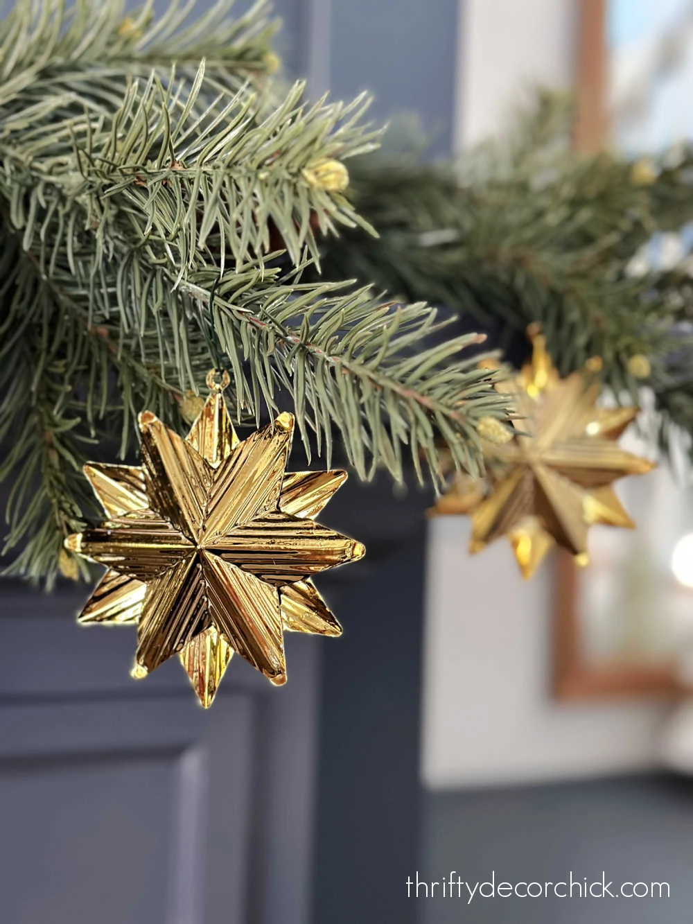 gold star ornaments hanging from garland