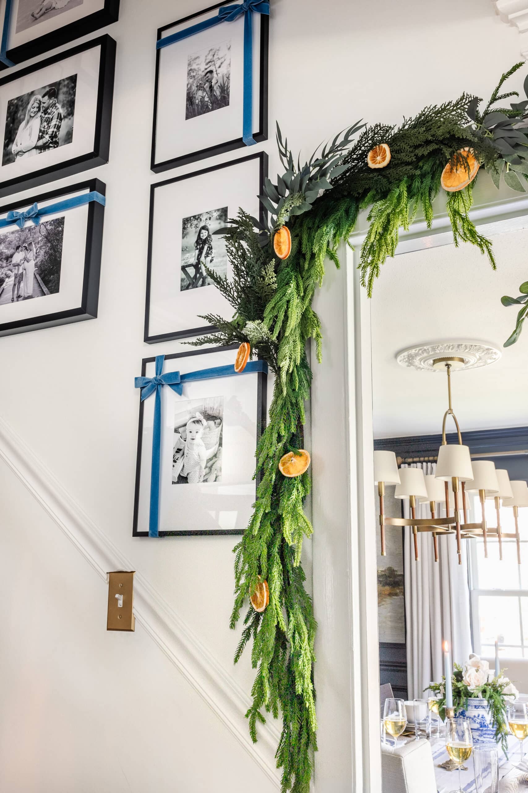 garland around a doorway with dried orange slices and blue ribbon